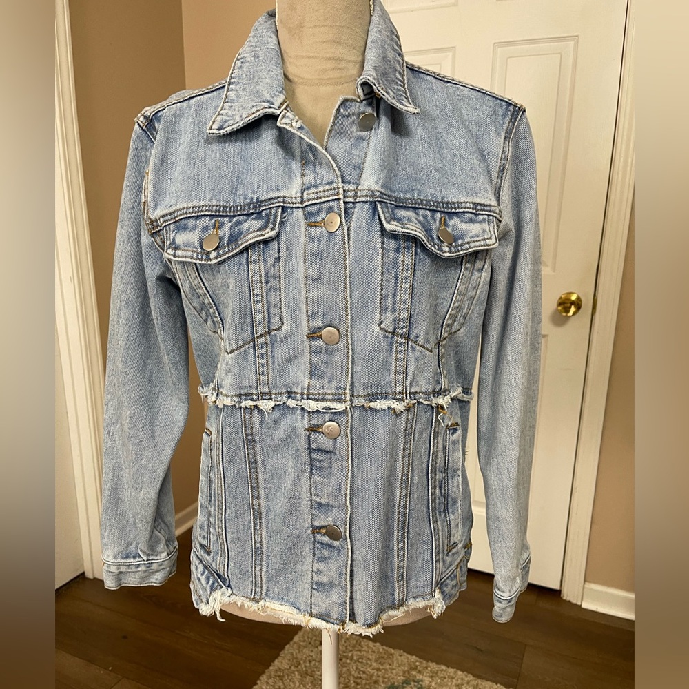 C.M.3. Outfitters Distressed light wash denim jacket, size small.